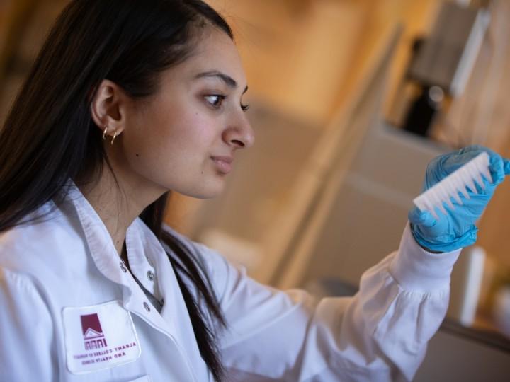 A student examines a lab sample